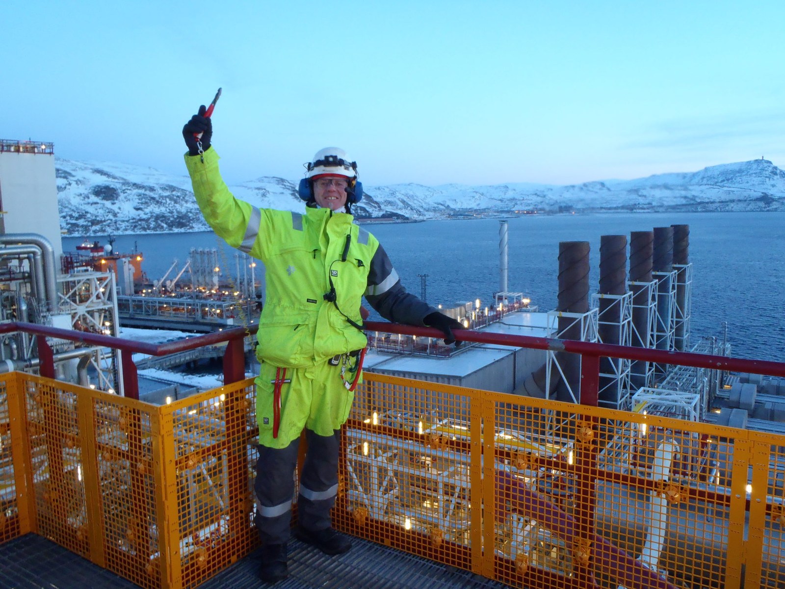Specialist with a radio and protective equipment at an industrial facility